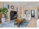 Stylish living room featuring tile flooring, an elegant fireplace, and comfortable seating area at 6951 Scrub Jay Dr, Sarasota, FL 34241