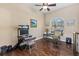 Well-lit office space features hardwood floors, a ceiling fan, and views of the outdoors from the natural light at 6951 Scrub Jay Dr, Sarasota, FL 34241