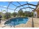Screened-in pool features a sun shelf and calming water views at 6951 Scrub Jay Dr, Sarasota, FL 34241