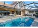 Screened-in pool with a patio area, bay window, and hot tub at 6951 Scrub Jay Dr, Sarasota, FL 34241