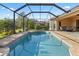 Inviting screened-in pool with a beautiful deck and view of the backyard landscaping at 6951 Scrub Jay Dr, Sarasota, FL 34241