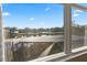 Scenic view from the home overlooking the pool, lake, and well-manicured lawns at 6951 Scrub Jay Dr, Sarasota, FL 34241