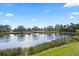 Beautiful tranquil water view showcasing the lush landscaping and bright blue skies at 6951 Scrub Jay Dr, Sarasota, FL 34241