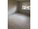 Cozy bedroom with neutral carpeting and a window offering natural light at 7050 Fairway Bend Ln # 167, Sarasota, FL 34243