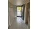 Inviting entryway with tile flooring and bright natural light streaming through the open front door at 7050 Fairway Bend Ln # 167, Sarasota, FL 34243