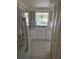Bright kitchen features white cabinetry, stainless steel sink, and modern appliances with a lovely view at 7050 Fairway Bend Ln # 167, Sarasota, FL 34243