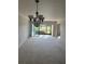 Spacious living room with chandelier, sliding glass doors to outdoor area, and neutral carpet at 7050 Fairway Bend Ln # 167, Sarasota, FL 34243