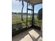 Enjoy outdoor living on this screened lanai with views of lush landscaping, a pond, and palm trees at 7050 Fairway Bend Ln # 167, Sarasota, FL 34243