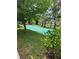 Shuffleboard court shaded by mature trees, set within a beautifully maintained community lawn at 7050 Fairway Bend Ln # 167, Sarasota, FL 34243