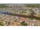 Beautiful aerial view of the neighborhood homes, canals, and mature landscaping in an idyllic setting at 7055 Kenwood Dr, North Port, FL 34287