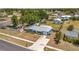 Aerial view of a blue single-story home with a large fenced yard, surrounded by mature trees at 7055 Kenwood Dr, North Port, FL 34287