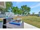 Backyard patio featuring outdoor seating, fire pit and charming custom shed at 7055 Kenwood Dr, North Port, FL 34287