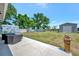 Large backyard featuring a storage shed and landscaping on a sunny day at 7055 Kenwood Dr, North Port, FL 34287