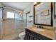 Bathroom featuring a glass-enclosed shower, modern vanity, and stylish fixtures at 7055 Kenwood Dr, North Port, FL 34287