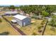 View of large detached garage with plenty of room in fenced backyard space and tropical landscaping at 7055 Kenwood Dr, North Port, FL 34287
