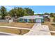 Charming blue single-story home with a well-kept lawn and attached garage at 7055 Kenwood Dr, North Port, FL 34287