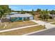 Charming blue single-story home with a well-kept lawn and attached garage at 7055 Kenwood Dr, North Port, FL 34287