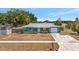 Charming blue single-story home with a well-kept lawn and attached garage at 7055 Kenwood Dr, North Port, FL 34287