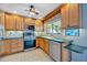 Bright kitchen showcases wood cabinets, stainless steel oven, and a window view at 7055 Kenwood Dr, North Port, FL 34287