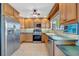 Traditional kitchen features stainless steel appliances, wood cabinets, and tile backsplash at 7055 Kenwood Dr, North Port, FL 34287