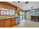 Open kitchen area with tile flooring, wood cabinets, and sliding glass door to patio at 7055 Kenwood Dr, North Port, FL 34287