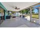 Large lanai with ceiling fan, view of the spacious backyard, and outdoor seating at 7055 Kenwood Dr, North Port, FL 34287