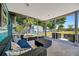 Screened in lanai features outdoor seating, ceiling and view of landscaped backyard at 7055 Kenwood Dr, North Port, FL 34287