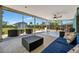 Screened in lanai features outdoor seating, ceiling fan and view of landscaped backyard at 7055 Kenwood Dr, North Port, FL 34287