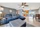 Open-concept living room with a comfortable leather sectional and a view into the kitchen at 7055 Kenwood Dr, North Port, FL 34287