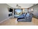 Comfortable living room featuring a large leather sofa, modern fireplace and a view to the outdoors at 7055 Kenwood Dr, North Port, FL 34287