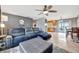 Open-concept living room with a comfortable leather sectional and a view into the kitchen at 7055 Kenwood Dr, North Port, FL 34287