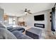 Inviting living room featuring modern fireplace, TV and dining area with sliding glass door to the porch at 7055 Kenwood Dr, North Port, FL 34287