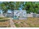 Custom shed with coastal decor, flower box and greenery at 7055 Kenwood Dr, North Port, FL 34287