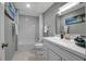 Modern bathroom featuring a white vanity, a shower-tub combination, and a bright, airy atmosphere at 709 84Th Nw St, Bradenton, FL 34209