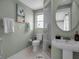 Fresh bathroom with a stylish vanity, glass-enclosed shower, and charming nautical accents at 709 84Th Nw St, Bradenton, FL 34209