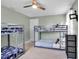 Spacious bedroom with comfortable bunk beds, ceiling fan, and functional decor at 709 84Th Nw St, Bradenton, FL 34209