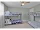 Bright bedroom featuring bunk beds, ceiling fan, ample space for sleep and play at 709 84Th Nw St, Bradenton, FL 34209