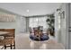 Light-filled dining area with a round glass table, four wicker chairs, and a coastal-themed color palette at 709 84Th Nw St, Bradenton, FL 34209