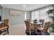 Bright dining area featuring wicker chairs, round glass table, beach-themed decor, and abundant natural light at 709 84Th Nw St, Bradenton, FL 34209