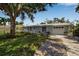 Charming single-story home with well-maintained lawn, lush landscaping, and an attached two-car garage at 709 84Th Nw St, Bradenton, FL 34209