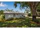 Charming single-story home with a well-manicured lawn and a cozy front porch seating area at 709 84Th Nw St, Bradenton, FL 34209