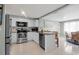 Kitchen boasts granite countertops, stainless steel appliances, white cabinets, and tiled backsplash at 709 84Th Nw St, Bradenton, FL 34209