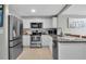 Kitchen boasts granite countertops, stainless steel appliances, white cabinets, and tiled backsplash at 709 84Th Nw St, Bradenton, FL 34209