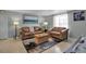 Bright living room with neutral walls, comfortable leather seating, and an adjacent dining area at 709 84Th Nw St, Bradenton, FL 34209