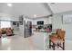 The kitchen features stainless steel appliances and is open to the living room with comfortable seating at 709 84Th Nw St, Bradenton, FL 34209