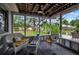 Screened-in porch with comfortable seating and view of the lush backyard at 709 84Th Nw St, Bradenton, FL 34209