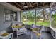 Screened-in porch with comfortable seating and view of the lush backyard at 709 84Th Nw St, Bradenton, FL 34209