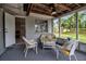 Charming screened-in porch with comfortable seating and a peaceful backyard view at 709 84Th Nw St, Bradenton, FL 34209