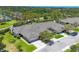 Aerial view of a home surrounded by lush landscaping, with a nearby waterway at 7374 Royal Birkdale Dr # 15D, Sarasota, FL 34238