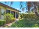 Backyard featuring lush vegetation, a beautiful garden and lovely stone path at 7374 Royal Birkdale Dr # 15D, Sarasota, FL 34238